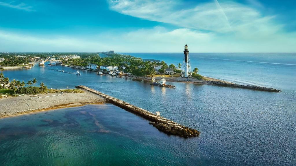 Aerial view of Hillsboro Inlet Lighthouse, boating channel and Atlantic Ocean near Lighthouse Point, Florida